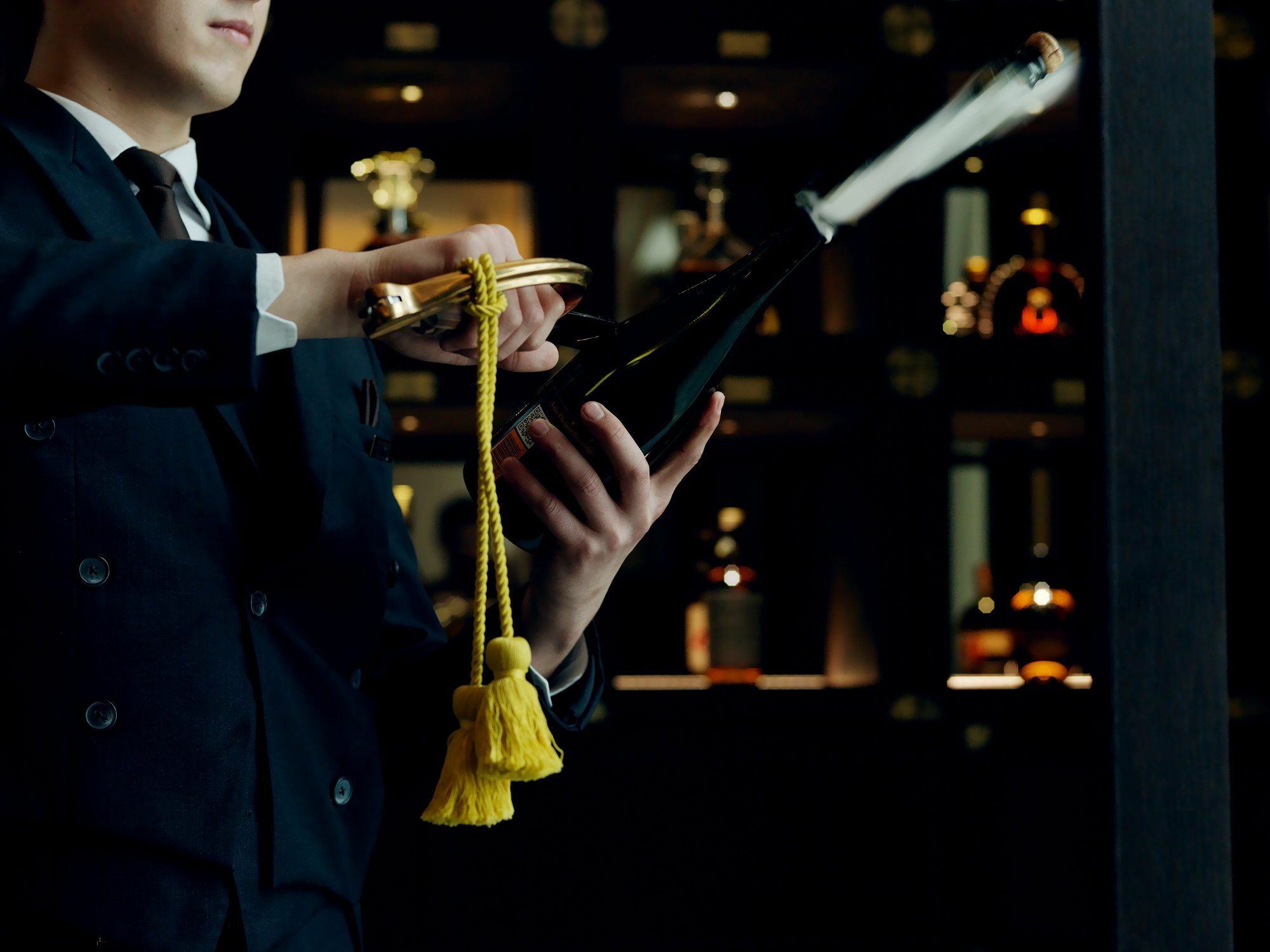 The St. Regis Astana Hotel Eksteriør billede A wine waiter opening a bottle of wine