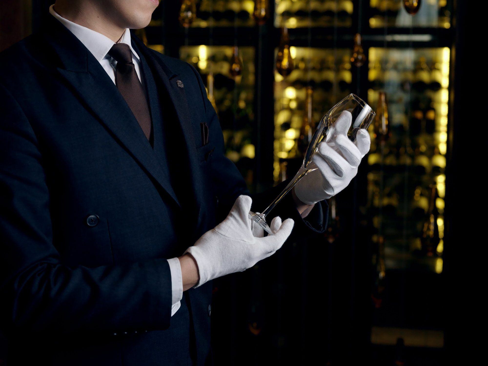 The St. Regis Astana Hotel Eksteriør billede A sommelier inspecting a bottle of wine